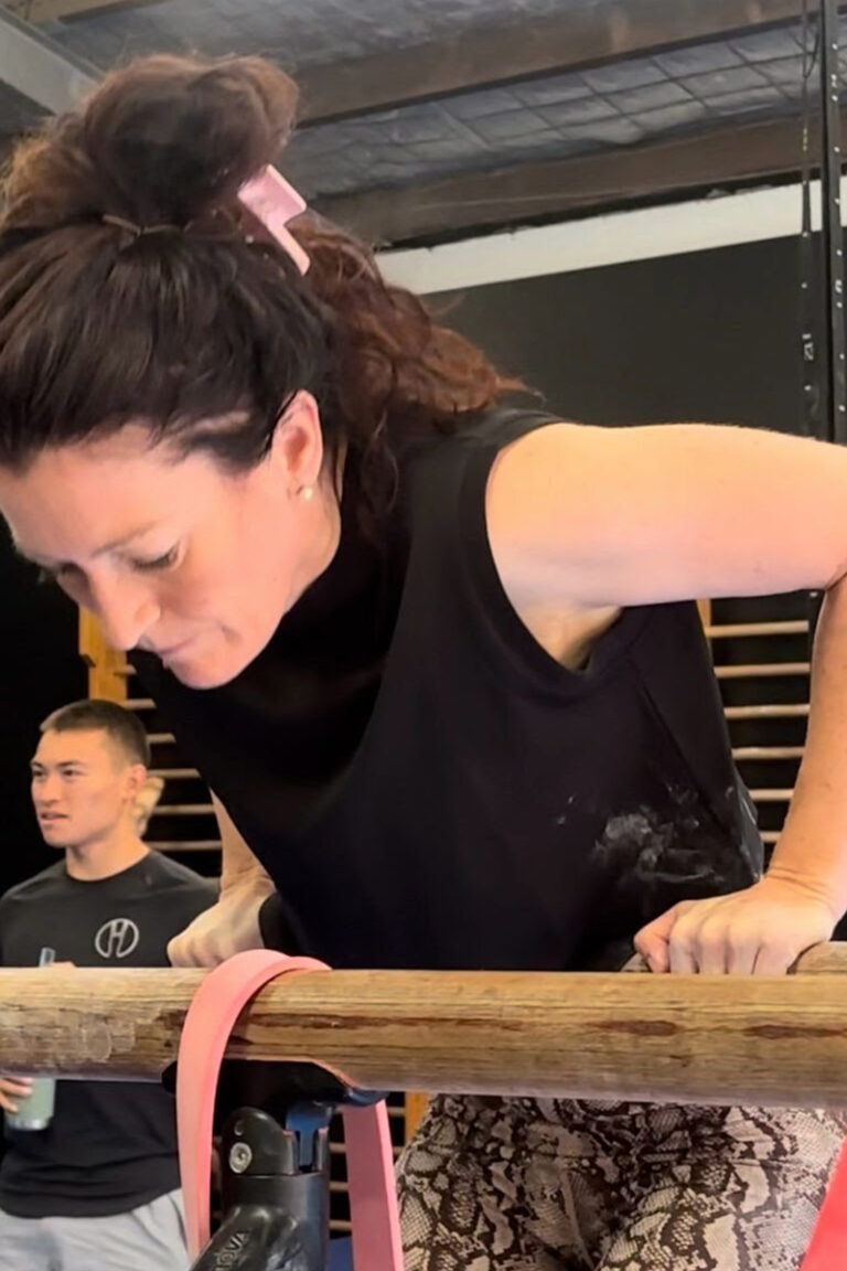 Photo of adults doing gymnastics strength training classes focused on strength training, mobility training, and skill training.