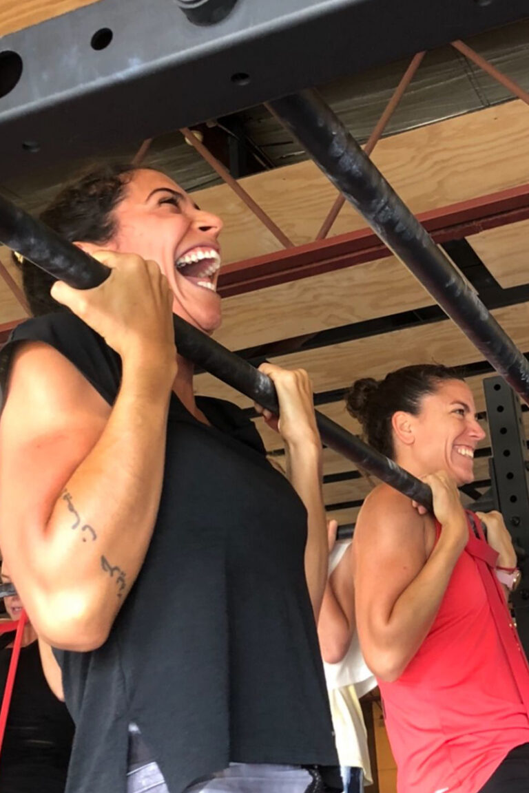 Photo of adults doing gymnastics strength training classes focused on strength training, mobility training, and skill training.